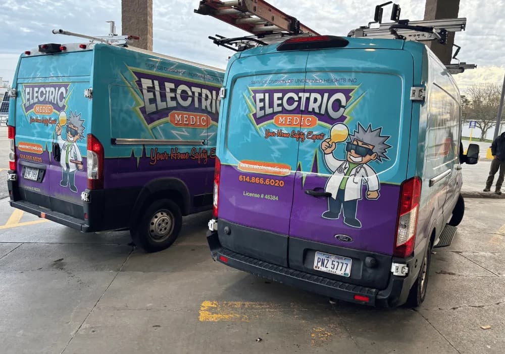 Electric Medic team member standing beside company service truck in Columbus